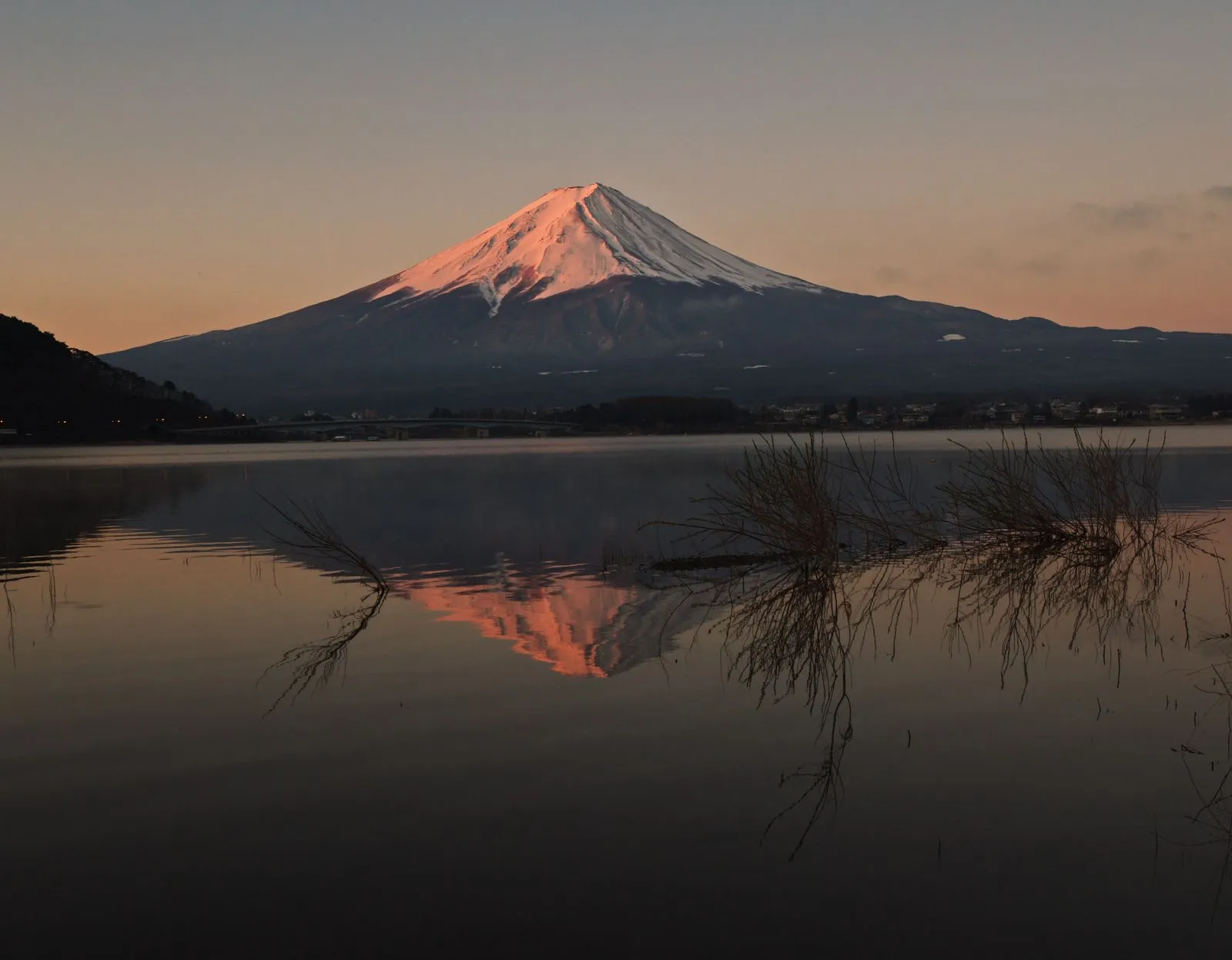 Mt Fuji glowing pink at dawn, reflected in Lake Kawaguchi
