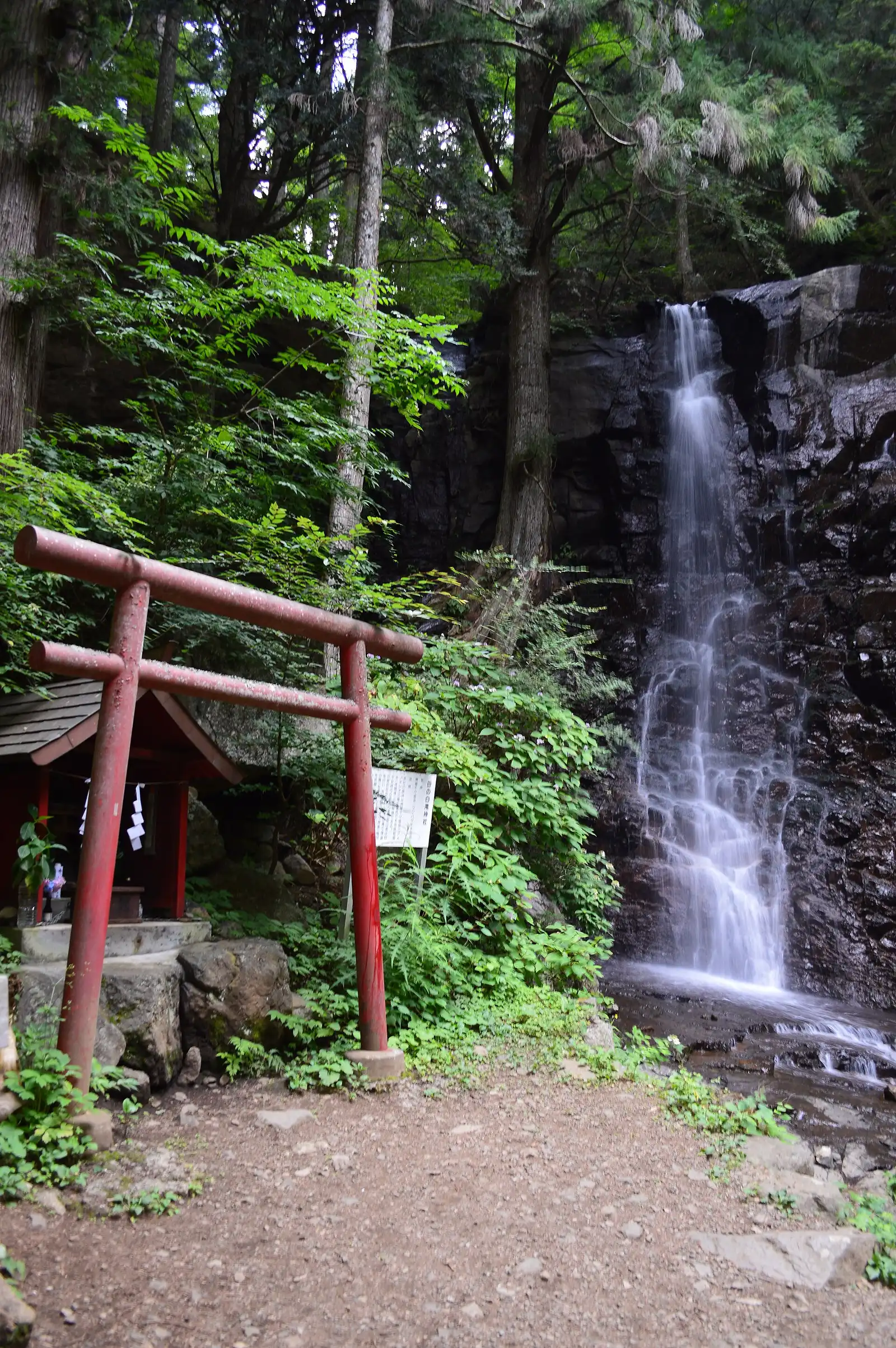 Haha-no-shirataki waterfall with a red torii and small shrine