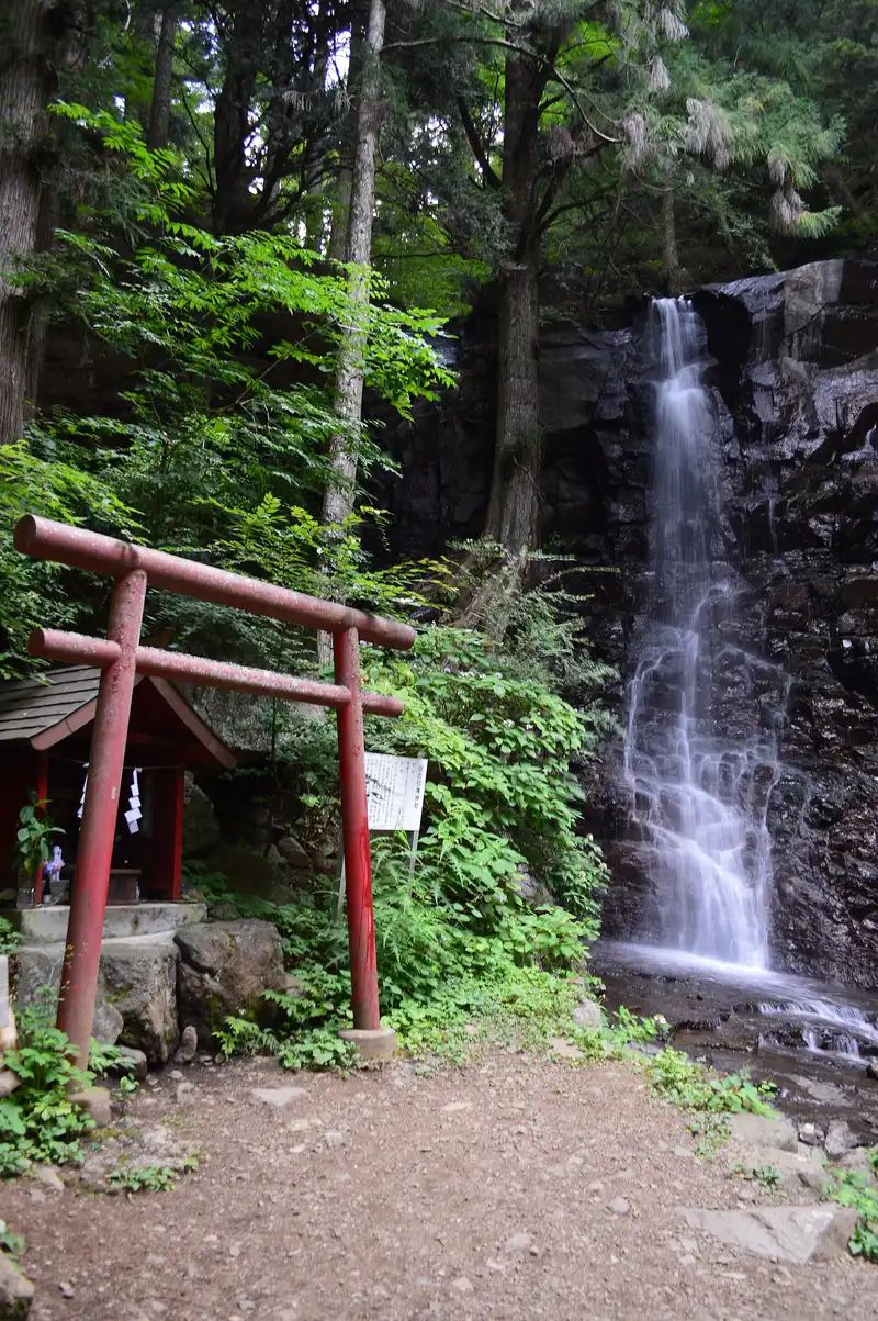 Haha-no-shirataki waterfall with a red torii and small shrine