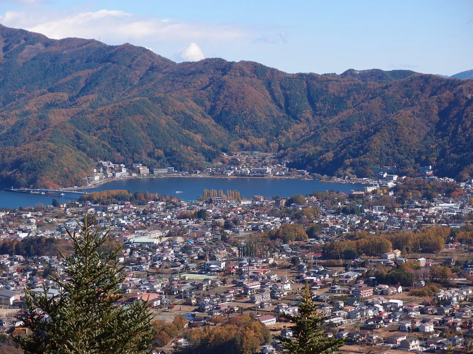 Fujikawaguchiko town spread along Lake Kawaguchi, autumn-coloured hills behind