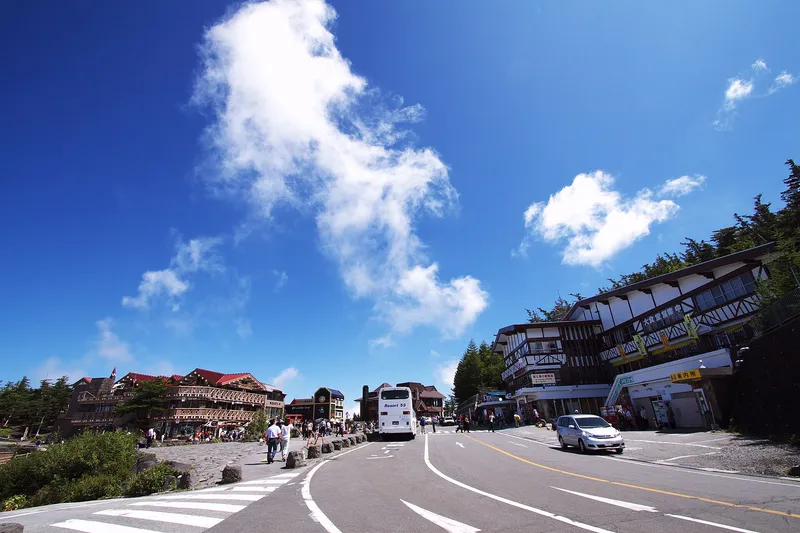 Road and lodges at the Fuji Subaru Line 5th Station, deep blue sky